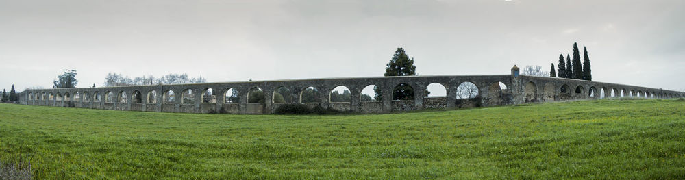 Built structure on grass against sky