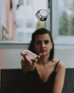 Portrait of young woman holding camera