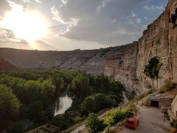 Scenic view of trees amidst rock formations against sky