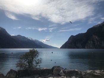 Scenic view of sea and mountains against sky