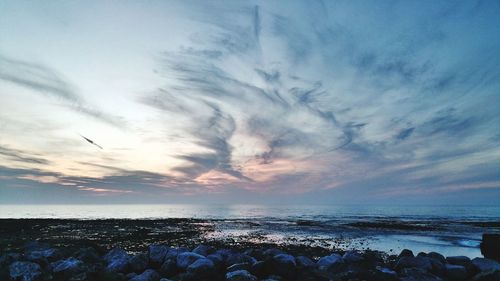 Scenic view of sea against cloudy sky