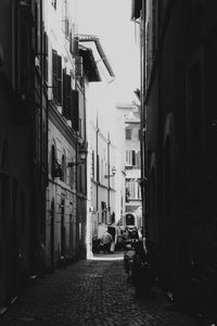 Narrow street amidst buildings in city