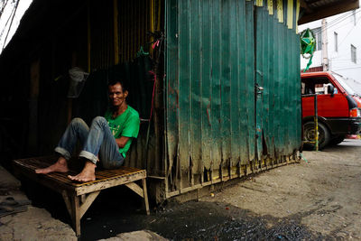 Portrait of a smiling young woman sitting outdoors