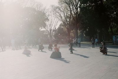 Group of people walking in park during winter