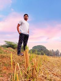 Full length of man on field against sky during sunset