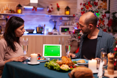 Man and woman having food at table