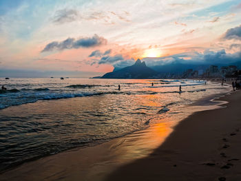 Scenic view of beach against sky during sunset