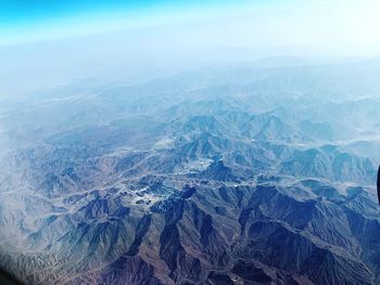 High angle view of snowcapped mountains against sky