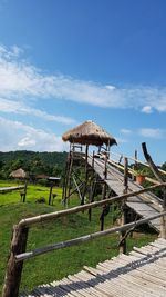 Thatched roof on land against sky