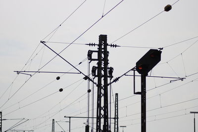 Low angle view of electricity pylon against sky