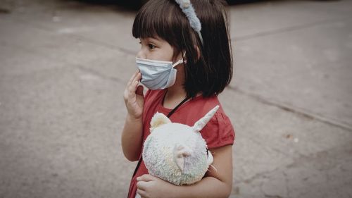 Full length of woman holding toy car on street