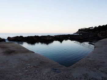 Scenic view of beach against clear sky