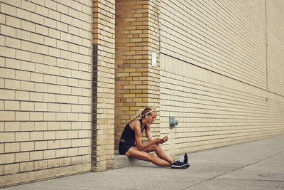 Young woman using mp3 player