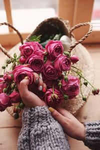 Close-up of hand holding rose bouquet