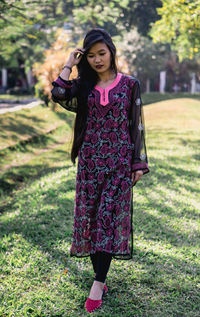 Full length of woman standing on field