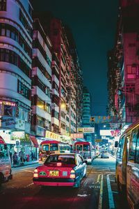 View of city street and buildings at night