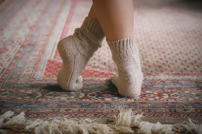 Low section of woman walking on rug