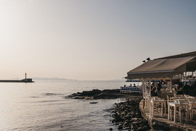 People at seaside restaurant by the old port in hora, mykonos town, greece.