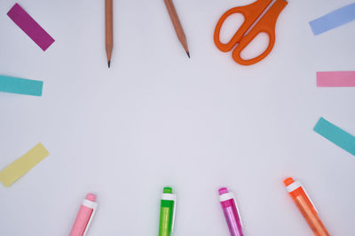 High angle view of colored pencils on white table