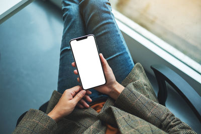 Midsection of man using mobile phone