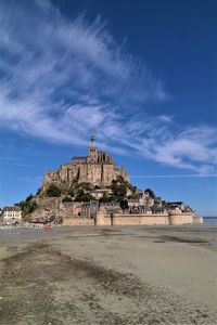 Built structure on beach against sky