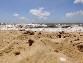 Surface level of beach against sky