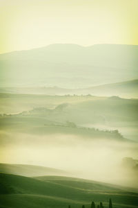 Sunrise with fog over a valley in tuscany - italy xii