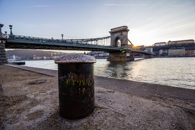 Bridge over river with buildings in distance