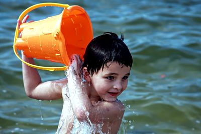 Portrait of smiling boy playing in water