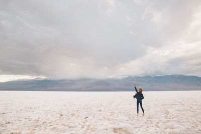 Rear view of woman standing on sand at death valley national park