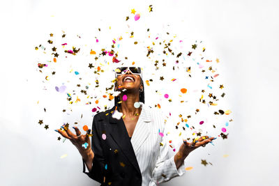 Portrait of smiling young woman against white background