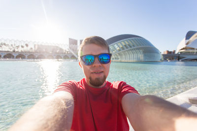 Portrait of young man against sky