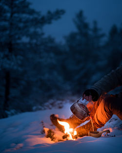 Coffee from a wood fire in the forest at winter.