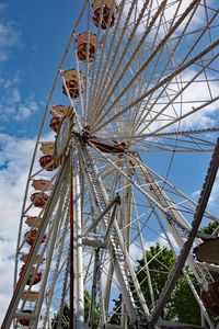 Low angle view of ferris wheel against blue sky