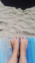 Low section of woman relaxing on beach