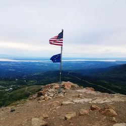 Flag on landscape against sky