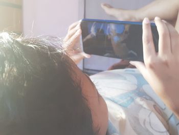 Midsection of man using mobile phone