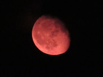 Low angle view of moon against dark sky