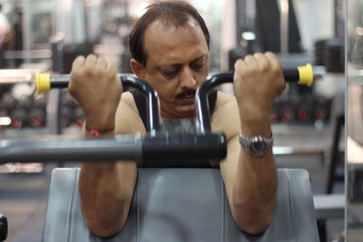 Mature man exercising at gym