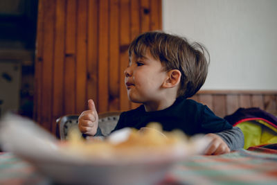 Boy looking away at home