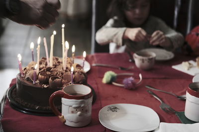 Close-up of illuminated candles on table