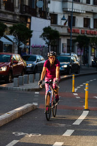 Man riding bicycle on city street