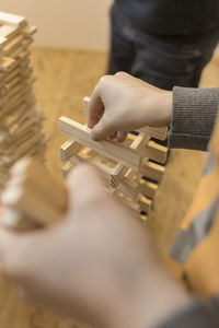 Cropped hands of child stacking block removal game