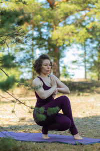 Young woman exercising on field