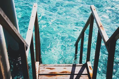 High angle view of steps by swimming pool