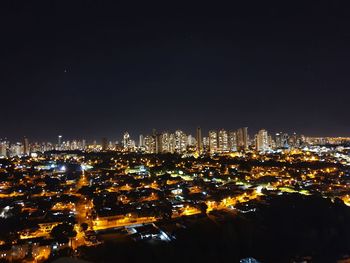 High angle view of illuminated buildings against sky at night