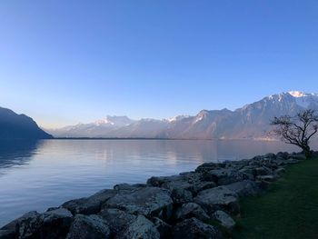 Scenic view of lake against clear blue sky