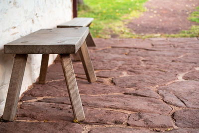 High angle view of empty bench on colonial flagstone porch