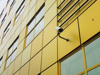 Low angle view of security camera on building