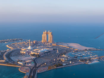 High angle view of city by buildings against sky